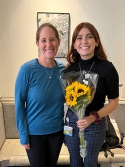 PhD Candidate Gabriella Rubert holding sunflowers