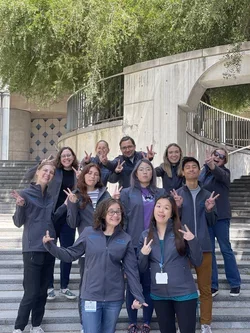 Group wearing new lab jackets and making funny faces
