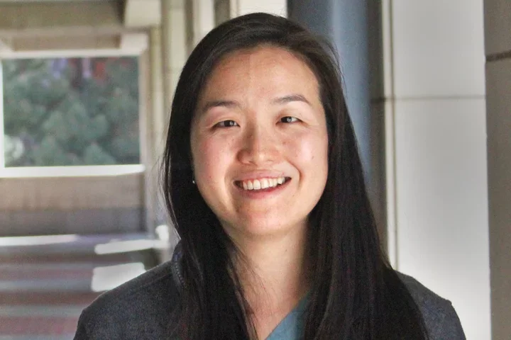 Elinor Lee standing in hallway outside building