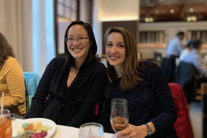 two lab members enjoying group dinner at Fogo De Chao