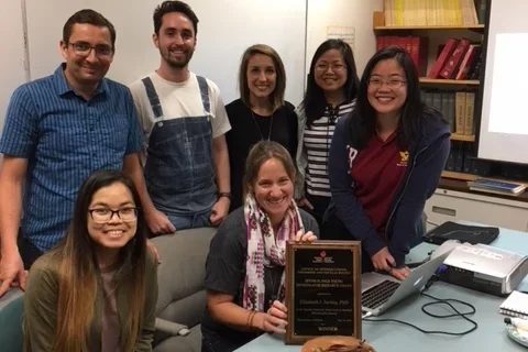 Group celebrating with cake