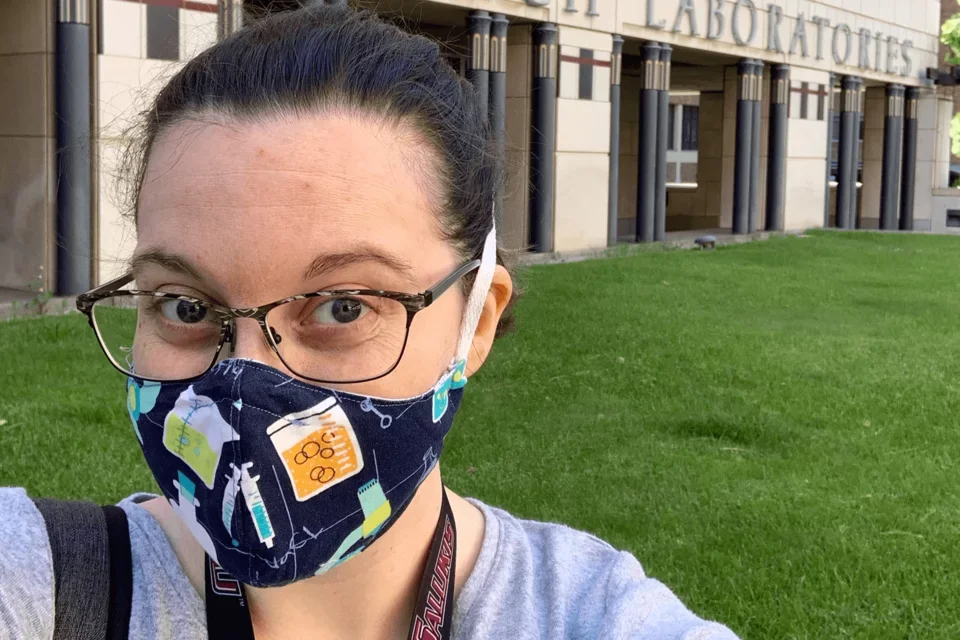 Postdoc Kelsey wearing mask outside