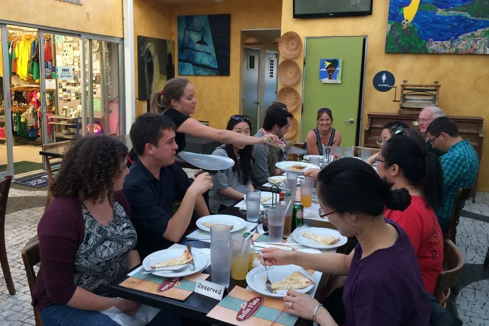 Group enjoying pizza at restaurant