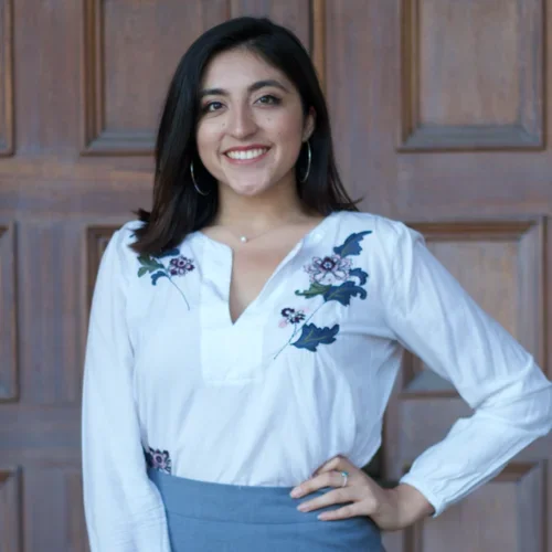 Madeline Guajardo standing in front of a door
