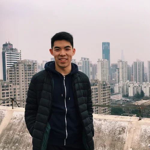 Timothy Yu standing in front of cityscape