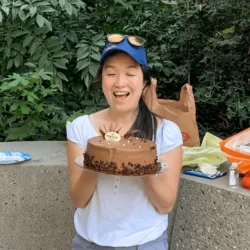 MCIP graduate student Elinor successfully defended her thesis, celebrates with cake