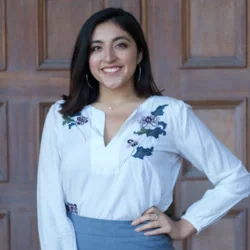 Madeline Guajardo standing in front of a door