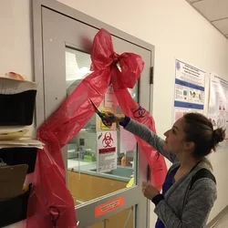 Pauline cutting the ribbon at the grand opening of the Tissue Culture suite