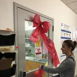 Pauline cutting the ribbon at the grand opening of the Tissue Culture suite