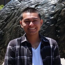 Rodrigo BaltazarNuez standing in front of statue
