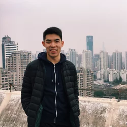 Timothy Yu standing in front of cityscape