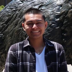 Rodrigo BaltazarNuez standing in front of statue